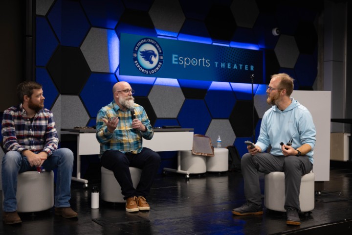 A panel discussion between three tech professionals